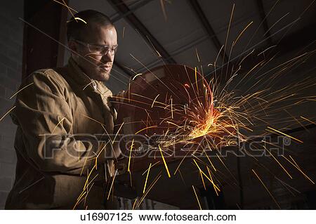 Stock Photography - Steel grinder working in metal shop. Fotosearch