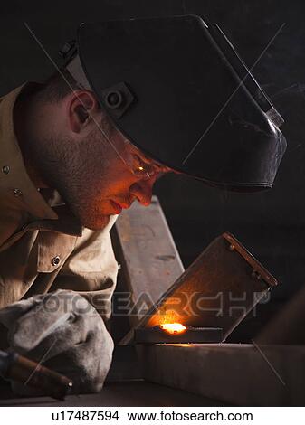 Picture - Steel worker doing quality check. Fotosearch