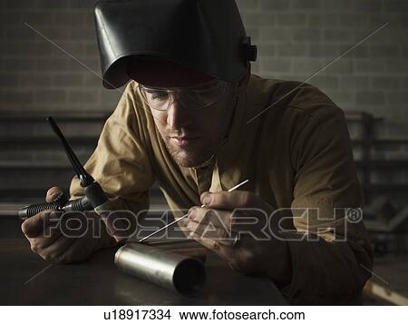 Picture - Steel worker in metal shop. Fotosearch