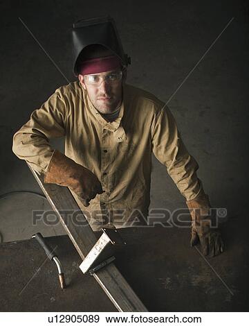 Stock Photo - Steel worker in metal shop. Fotosearch