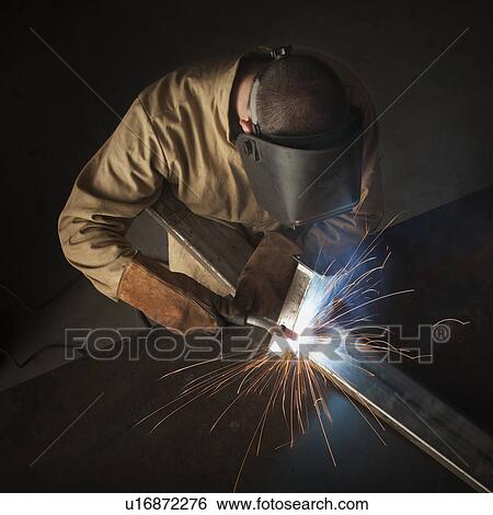Stock Photograph - Steel worker in metal shop. Fotosearch
