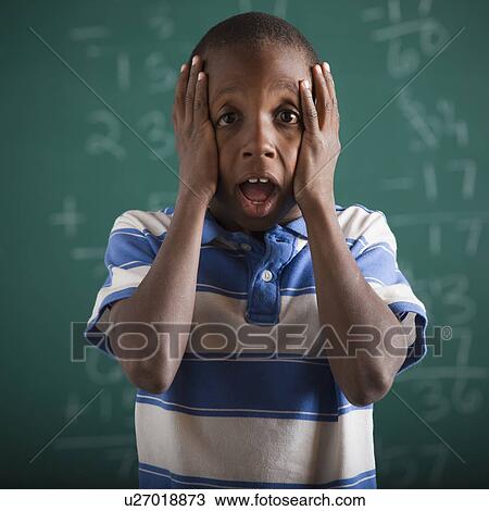 Stock Image - Student in front of chalkboard. Fotosearch
