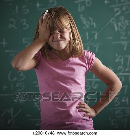 Stock Photo - Student in front of chalkboard. Fotosearch