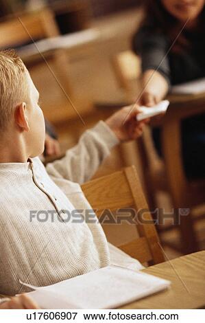 Students passing notes View Large Photo Image Stock Photo - Students passing notes. Fotosearch