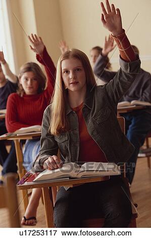 Stock Photo - Students raising hands in classroom. Fotosearch