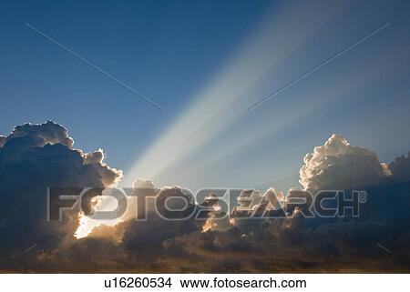 Picture - Sunset behind clouds. Fotosearch