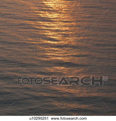 Stock Image - Sunset over ocean. Fotosearch