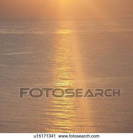 Stock Image - Sunset over ocean. Fotosearch