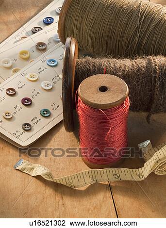 Stock Image - Thread buttons and measuring tape. Fotosearch