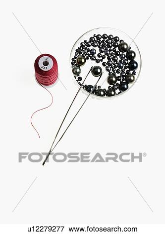 Stock Photo - Tweezers thread and pearls. Fotosearch