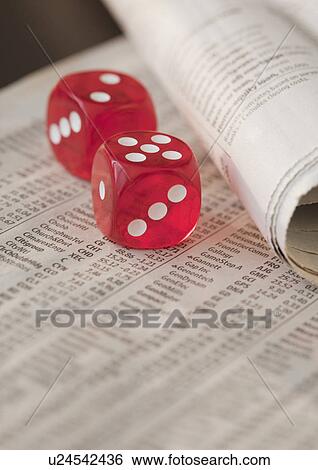 Stock Photograph - Two dice on newspaper. Fotosearch
