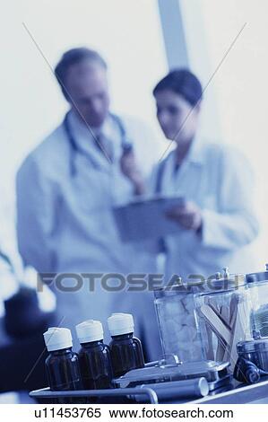 Two Doctors looking at chart View Large Photo Image Stock Photography - Two Doctors looking at chart. Fotosearch