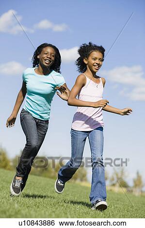 Two girls running View Large Photo Image Stock Photograph - Two girls running. Fotosearch