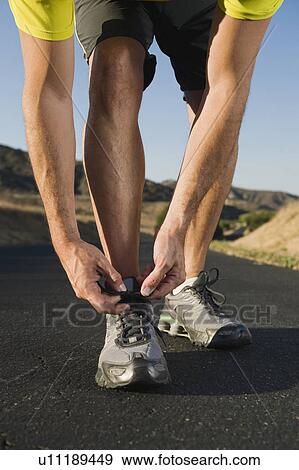 Tying shoelaces View Large Photo Image Stock Photo - Tying shoelaces. Fotosearch