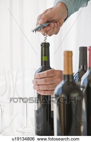 Stock Photograph - Uncorking wine. Fotosearch
