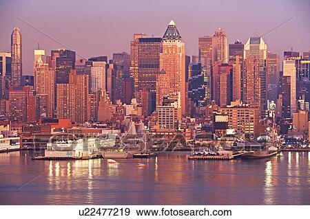 Stock Photo - Waterfront buildings at sunset. Fotosearch