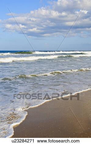 Stock Image - Waves at the beach. Fotosearch
