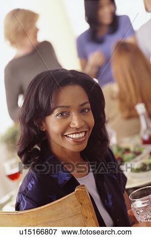 Stock Photo - Woman at dinner party. Fotosearch