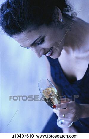Stock Image - Woman drinking champagne. Fotosearch