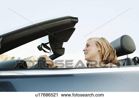 Woman driving convertible View Large Photo Image Stock Image - Woman driving convertible. Fotosearch