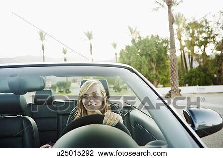 Woman driving convertible View Large Photo Image Stock Image - Woman driving convertible. Fotosearch