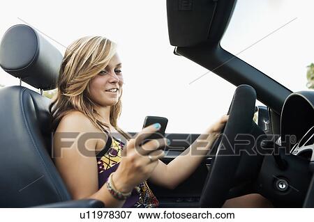 Woman driving convertible View Large Photo Image Stock Photo - Woman driving convertible. Fotosearch