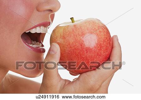 Stock Photograph - Woman eating apple. Fotosearch