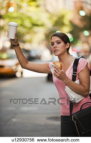 Stock Photograph - Woman hailing cab. Fotosearch