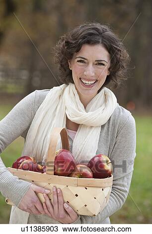 Woman holding basket of apples View Large Photo Image Stock Image - Woman holding basket of apples. Fotosearch