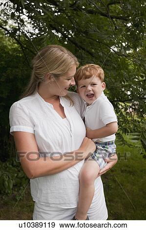 Stock Photo - Woman holding boy. Fotosearch