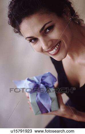 Stock Image - Woman holding gift. Fotosearch