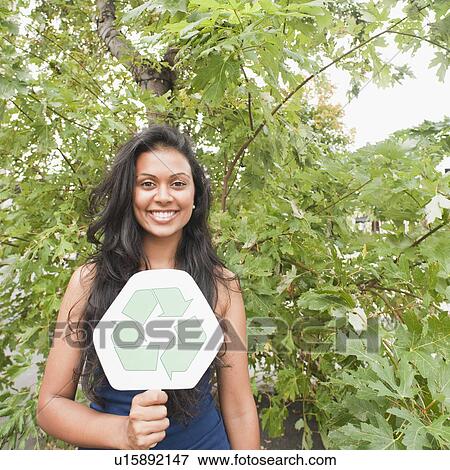 Stock Photo - Woman holding recycle sign. Fotosearch