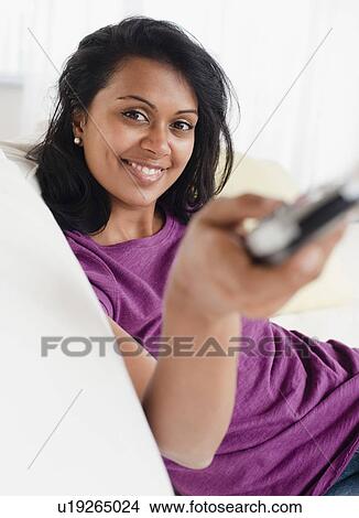 Woman holding remote control View Large Photo Image Picture - Woman holding remote control. Fotosearch