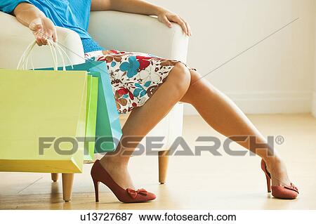 Stock Photo - Woman holding shopping bags. Fotosearch