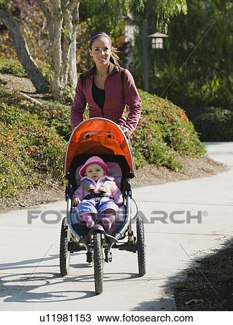 Stock Image - Woman jogging with stroller. Fotosearch