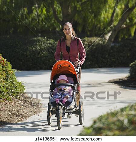 Stock Image - Woman jogging with stroller. Fotosearch
