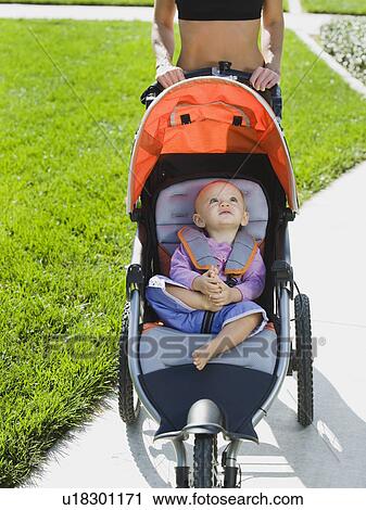 Stock Image - Woman jogging with stroller. Fotosearch
