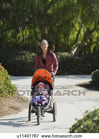 Woman jogging with stroller View Large Photo Image Stock Photo - Woman jogging with stroller. Fotosearch