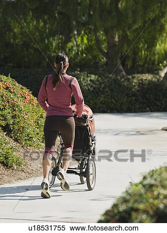 Stock Photography - Woman jogging with stroller. Fotosearch