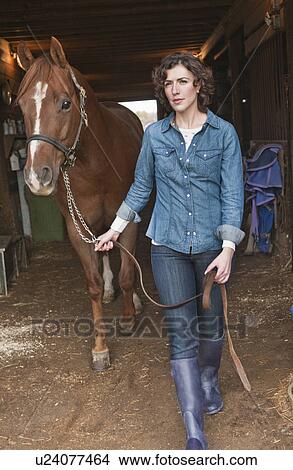 Woman leading horse View Large Photo Image Picture - Woman leading horse. Fotosearch