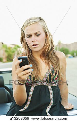Woman leaning on car View Large Photo Image Stock Photo - Woman leaning on car. Fotosearch