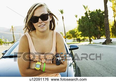Woman leaning on car View Large Photo Image Stock Photograph - Woman leaning on car. Fotosearch