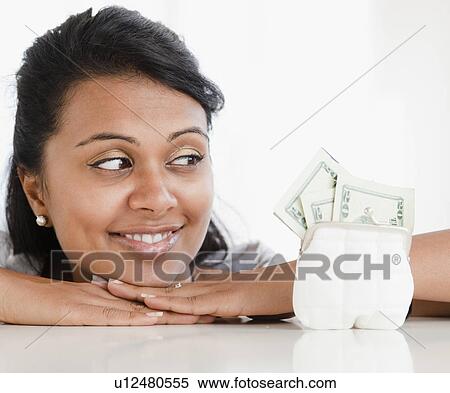 Woman looking at money View Large Photo Image Stock Photography - Woman looking at money. Fotosearch