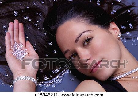 Woman lying down with diamonds View Large Photo Image Stock Image - Woman lying down with diamonds. Fotosearch
