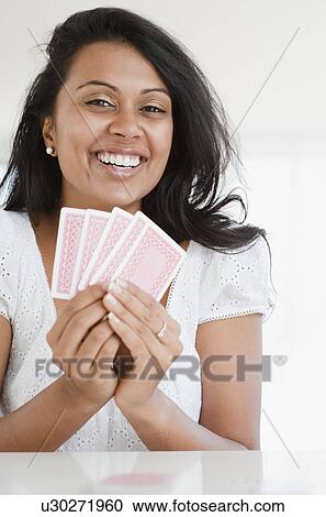 Stock Image - Woman playing cards. Fotosearch
