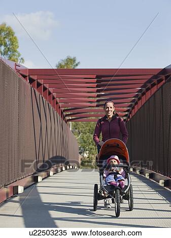 Woman pushing stroller View Large Photo Image Stock Photography - Woman pushing stroller. Fotosearch