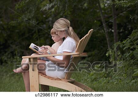 Stock Photo - Woman reading to son. Fotosearch