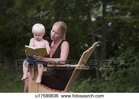 Stock Photograph - Woman reading to son. Fotosearch