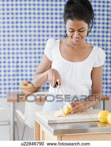 Woman slicing lemon View Large Photo Image Stock Image - Woman slicing lemon. Fotosearch