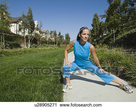 Stock Image - Woman stretching. Fotosearch